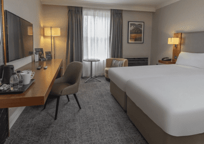 Interior of hotel rooms, featuring comfortable desk chairs, chaise longues, and tub chairs for a stylish, fresh look for this countryside retreat.