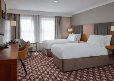 Interior of hotel rooms, featuring comfortable desk chairs, chaise longues, and tub chairs for a stylish, fresh look for this countryside retreat.